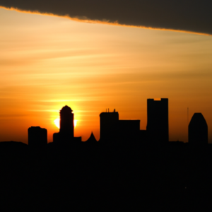 A city skyline in the morning with the sun rising in the background.