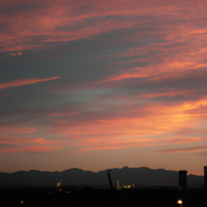 A colorful sunrise over a city skyline.