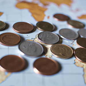 A set of coins with a world map in the background.